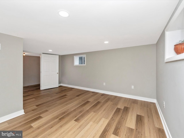 basement with light hardwood / wood-style floors