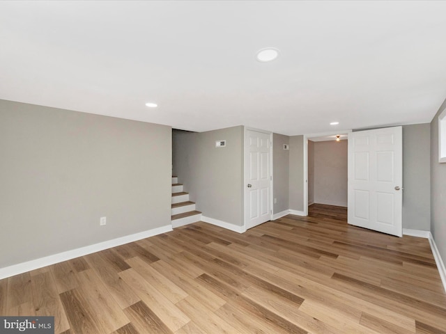 basement with light hardwood / wood-style floors