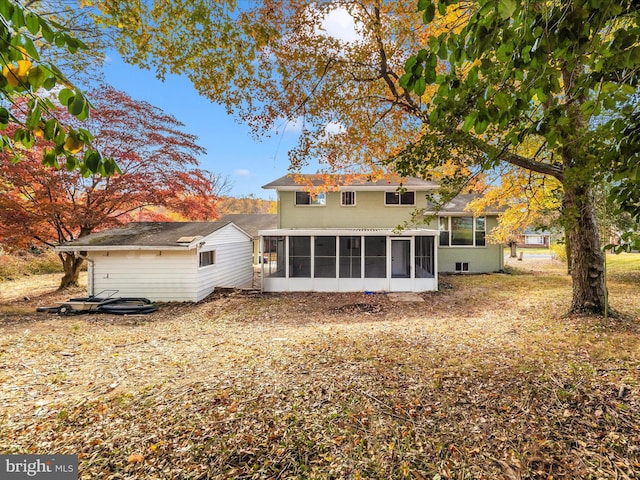 back of house featuring a sunroom