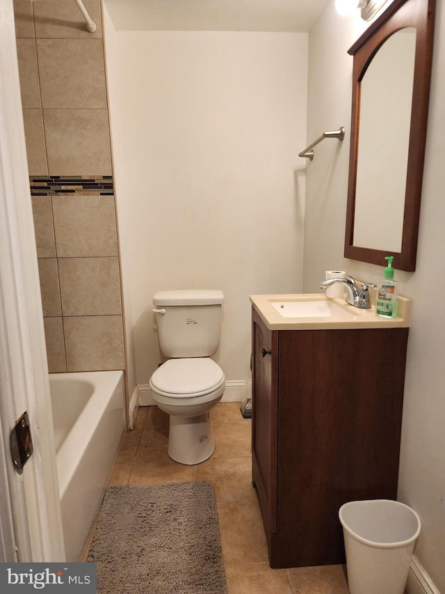 full bathroom with toilet, tile patterned flooring, tiled shower / bath, and vanity