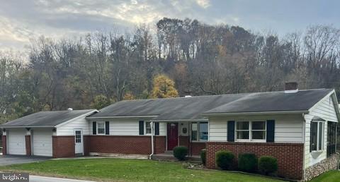 ranch-style house with a garage and a front yard