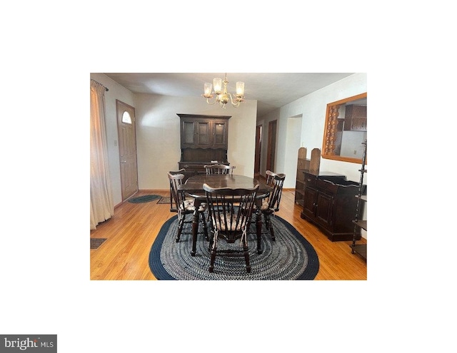 dining room with a notable chandelier and light hardwood / wood-style flooring