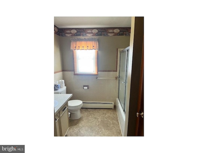 bathroom with vanity, toilet, tile walls, and baseboard heating