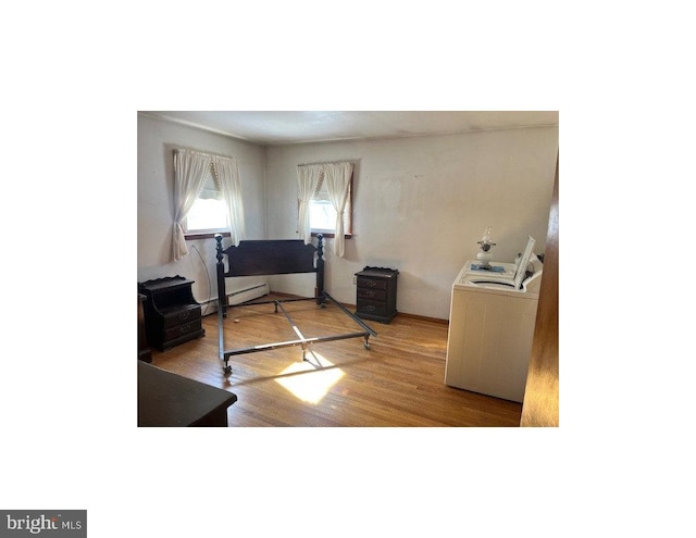 office space featuring washer / dryer and wood-type flooring