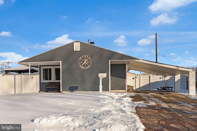 rear view of property featuring a carport