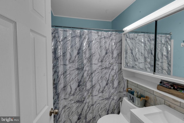 bathroom with tile walls, toilet, and a shower with curtain