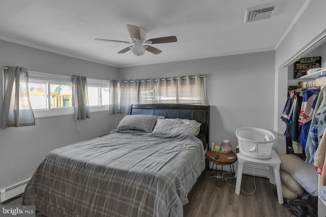 bedroom with ceiling fan, dark wood-type flooring, ornamental molding, a closet, and a baseboard radiator