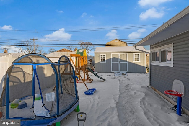 view of patio featuring a playground and a storage shed