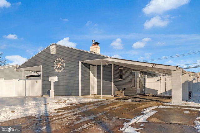 back of property featuring a carport