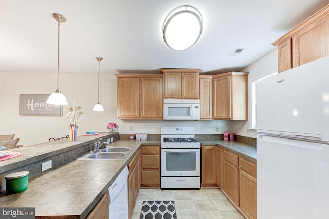 kitchen with hanging light fixtures, sink, and white appliances