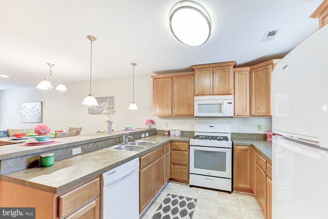 kitchen featuring sink, kitchen peninsula, pendant lighting, and white appliances