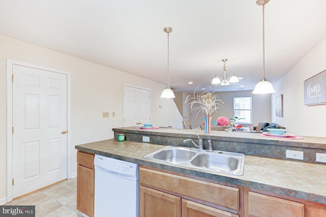 kitchen with white dishwasher, sink, decorative light fixtures, and a notable chandelier