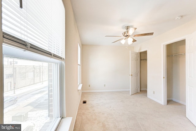 unfurnished bedroom featuring ceiling fan and light carpet