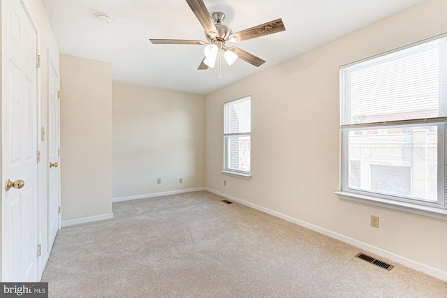 carpeted empty room featuring ceiling fan