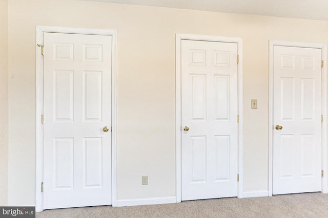 unfurnished bedroom featuring light carpet