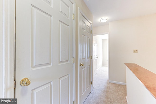 hallway with light colored carpet