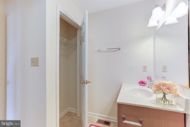 bathroom featuring tile patterned flooring and vanity