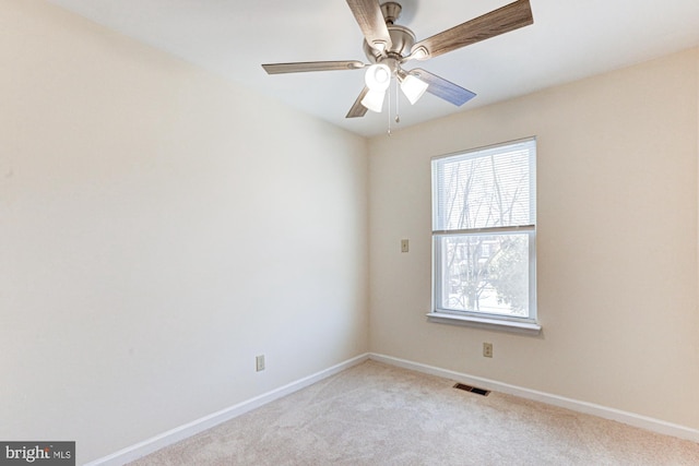 carpeted spare room with ceiling fan