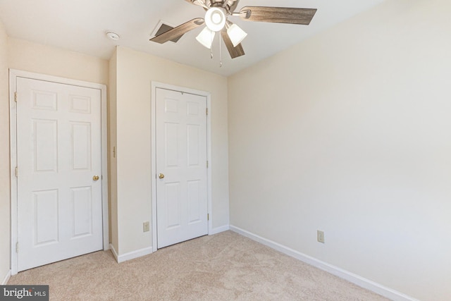 unfurnished bedroom featuring light carpet, ceiling fan, and a closet