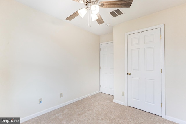 unfurnished bedroom with ceiling fan, a closet, and light colored carpet