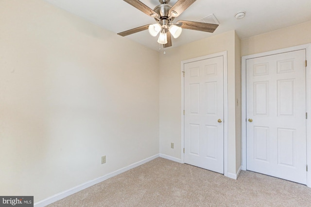 unfurnished bedroom with ceiling fan and light carpet