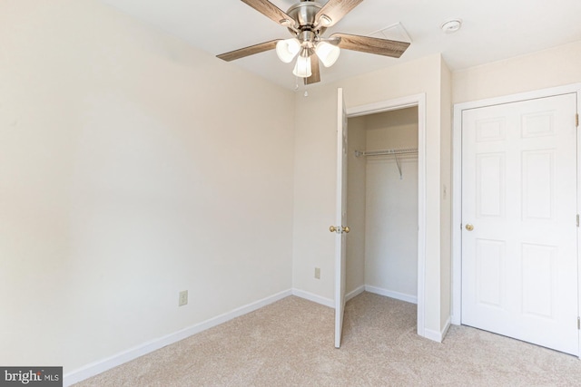 unfurnished bedroom with ceiling fan, a closet, and light colored carpet