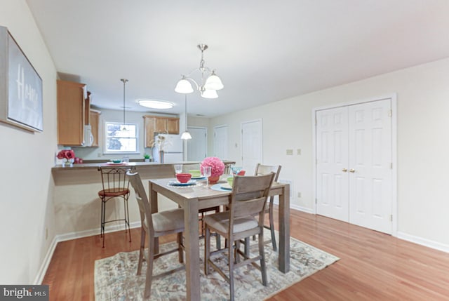 dining space featuring an inviting chandelier and hardwood / wood-style floors