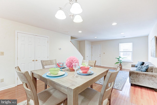 dining room featuring an inviting chandelier and light hardwood / wood-style floors