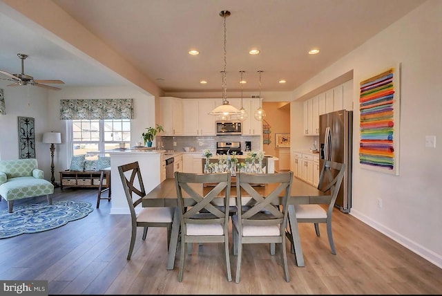 dining room featuring ceiling fan and light hardwood / wood-style floors