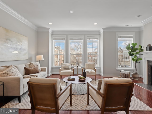 living room with hardwood / wood-style flooring, ornamental molding, and a premium fireplace