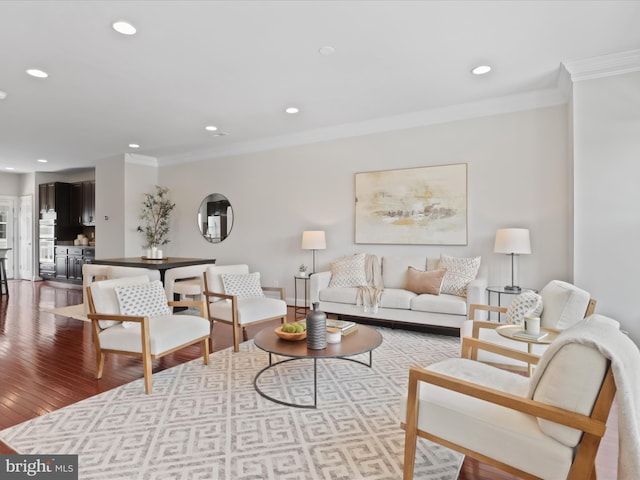 living room featuring light wood-type flooring and ornamental molding