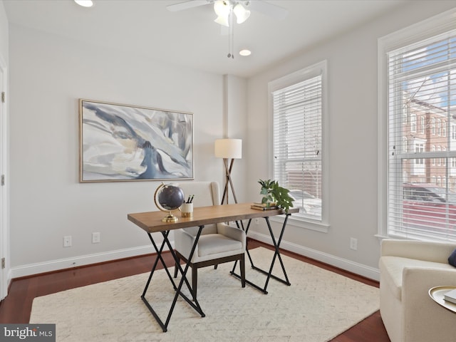 office area with ceiling fan, a wealth of natural light, and dark hardwood / wood-style flooring