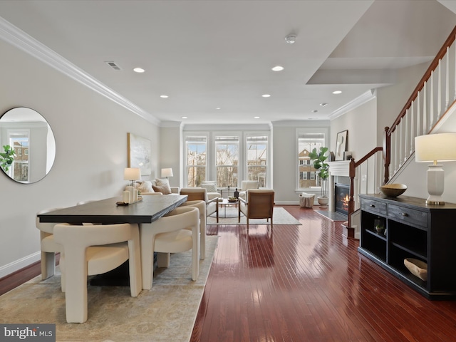 dining area featuring hardwood / wood-style floors and ornamental molding