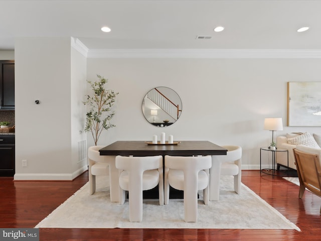 dining space featuring crown molding and hardwood / wood-style floors