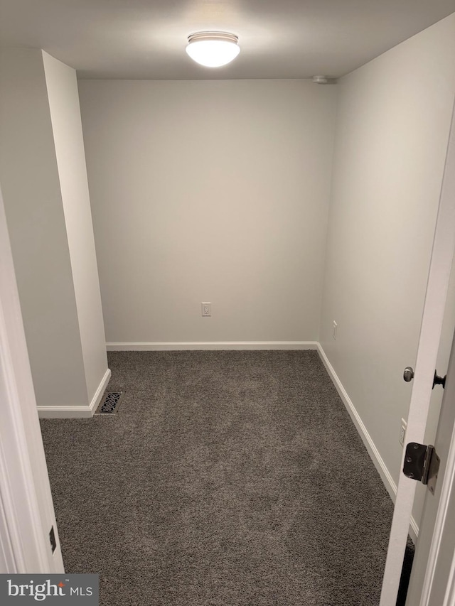 empty room featuring dark colored carpet