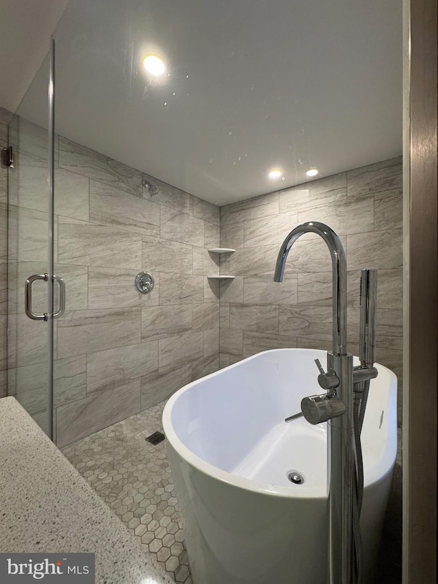 bathroom featuring walk in shower and sink