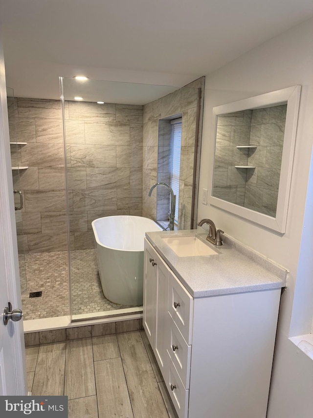 bathroom with vanity and independent shower and bath