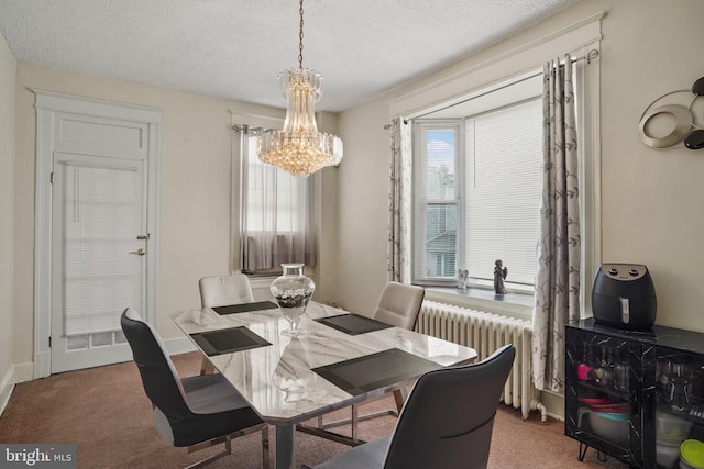 carpeted dining room with radiator, a chandelier, and a textured ceiling