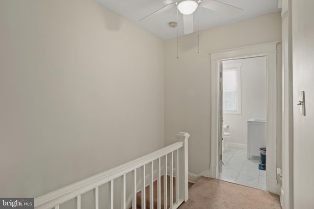 hallway featuring light colored carpet