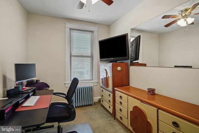 home office featuring radiator, light carpet, and ceiling fan