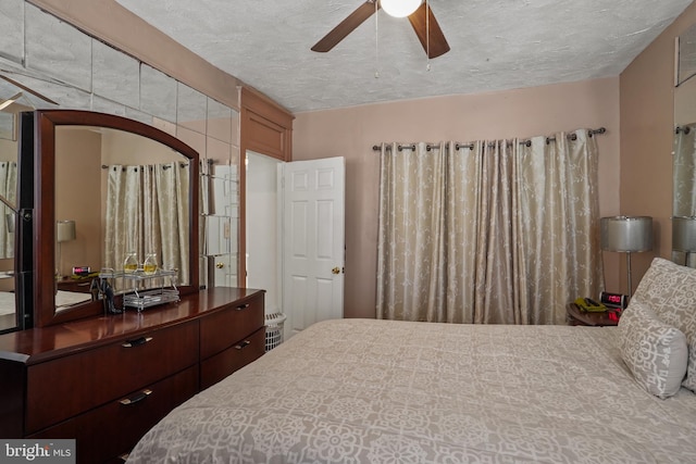 bedroom featuring a textured ceiling and ceiling fan