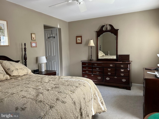 carpeted bedroom featuring baseboards and ceiling fan