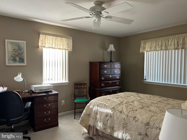 bedroom featuring ceiling fan, baseboards, and light carpet