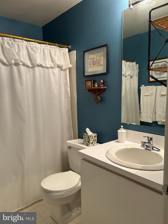 full bathroom featuring tile patterned flooring, toilet, and vanity