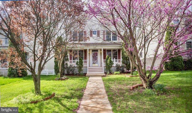 view of front of property featuring a front lawn and covered porch