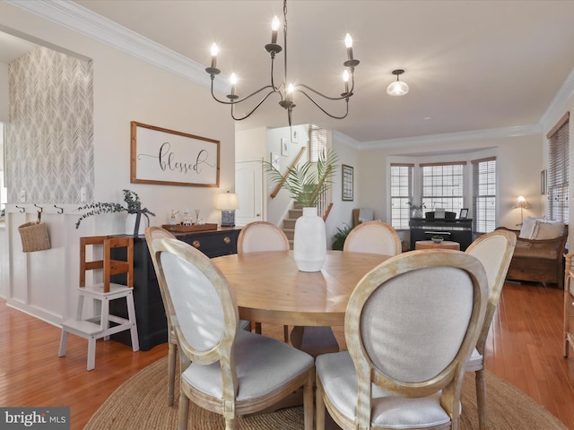 dining space featuring light hardwood / wood-style flooring and ornamental molding