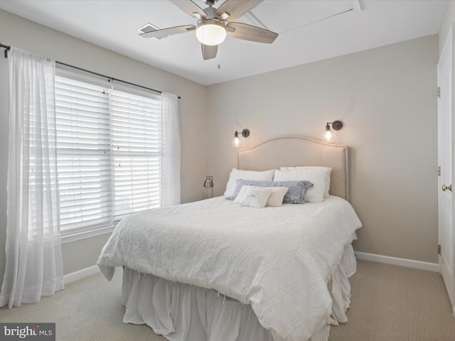 carpeted bedroom featuring multiple windows and ceiling fan