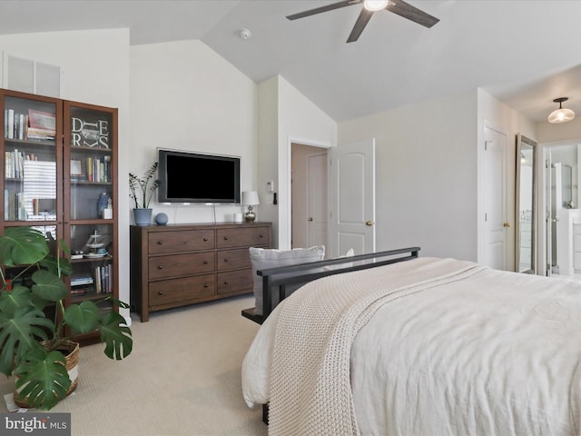 bedroom featuring ceiling fan, lofted ceiling, light colored carpet, and ensuite bath