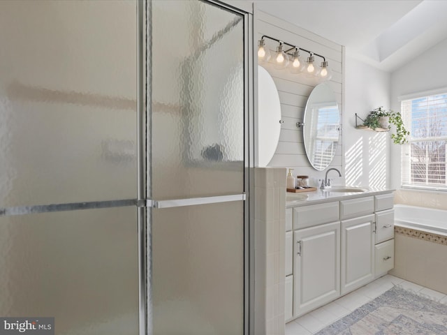 bathroom featuring tile patterned flooring, shower with separate bathtub, lofted ceiling, and vanity