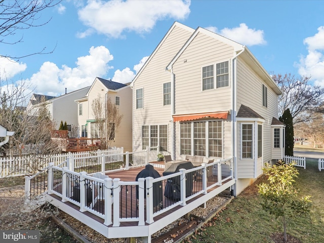 back of property with a wooden deck